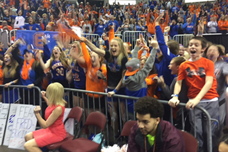 Fans in orange and blue cheer.