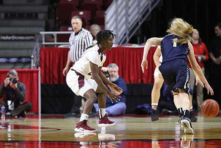 One player dribbles while opposing player attempts to defend. 