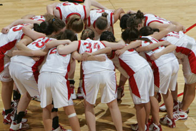 Team huddle on court.